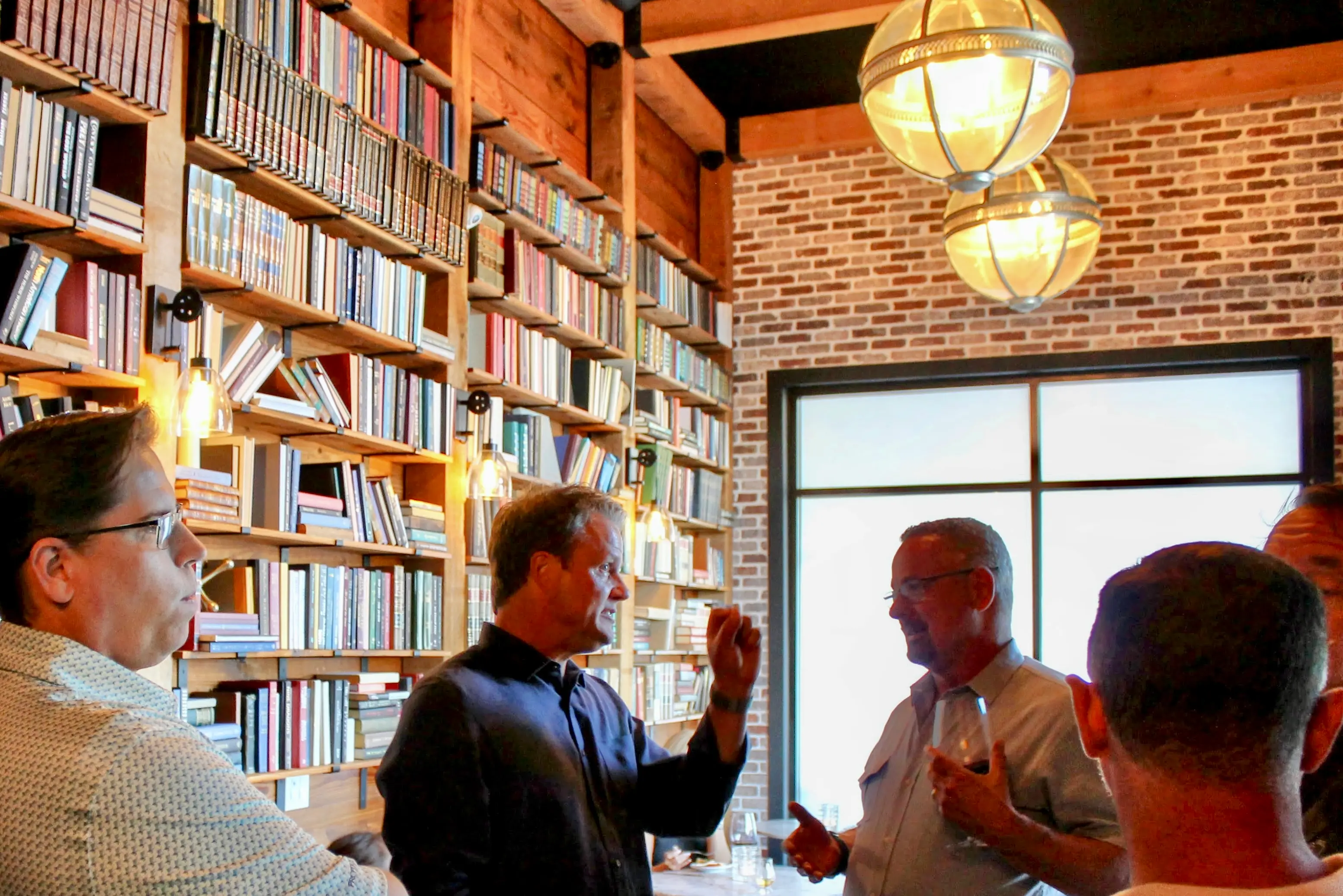 Team gathering at bookshelf bar
